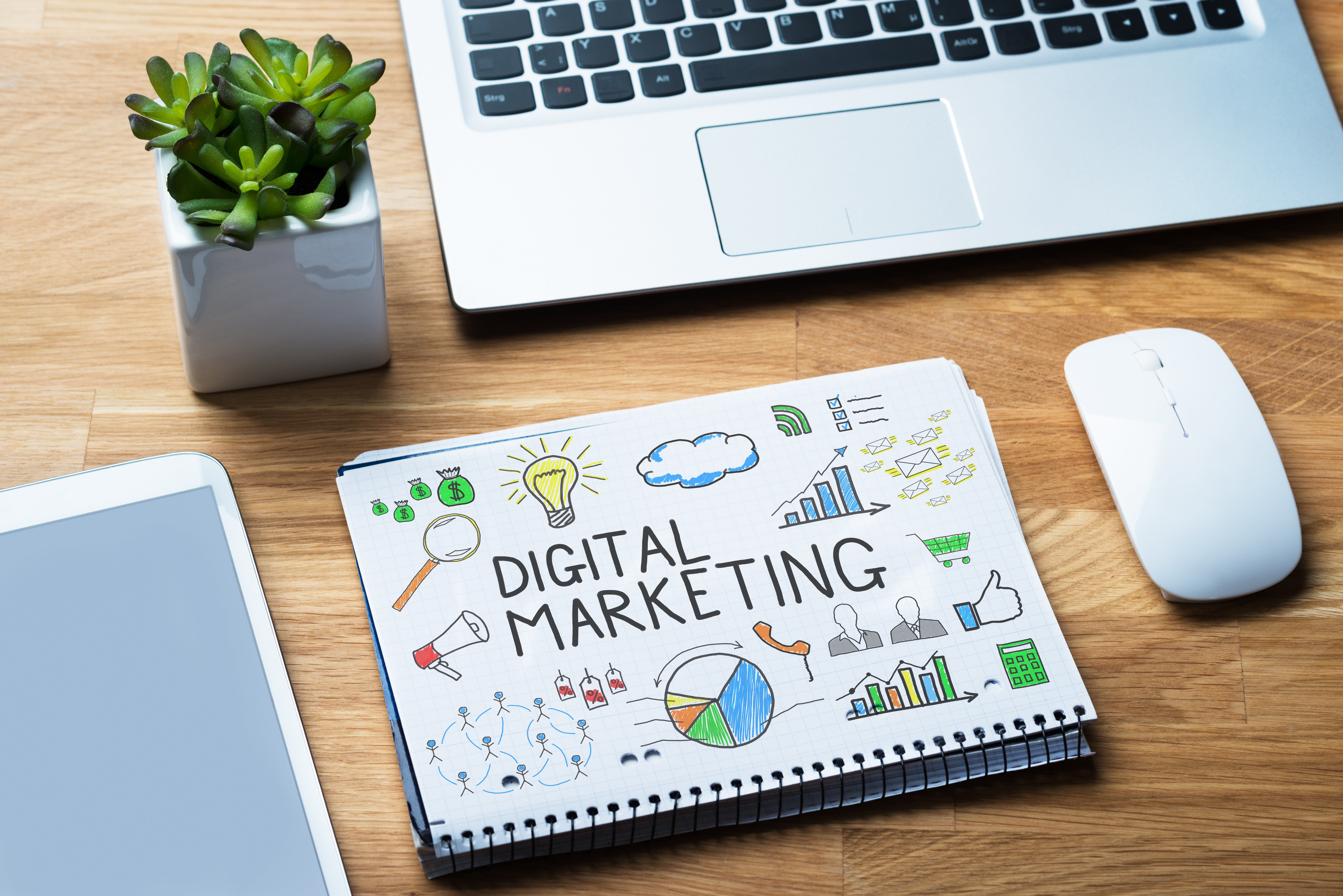 Notepad Showing Digital Marketing Diagram On Wooden Desk